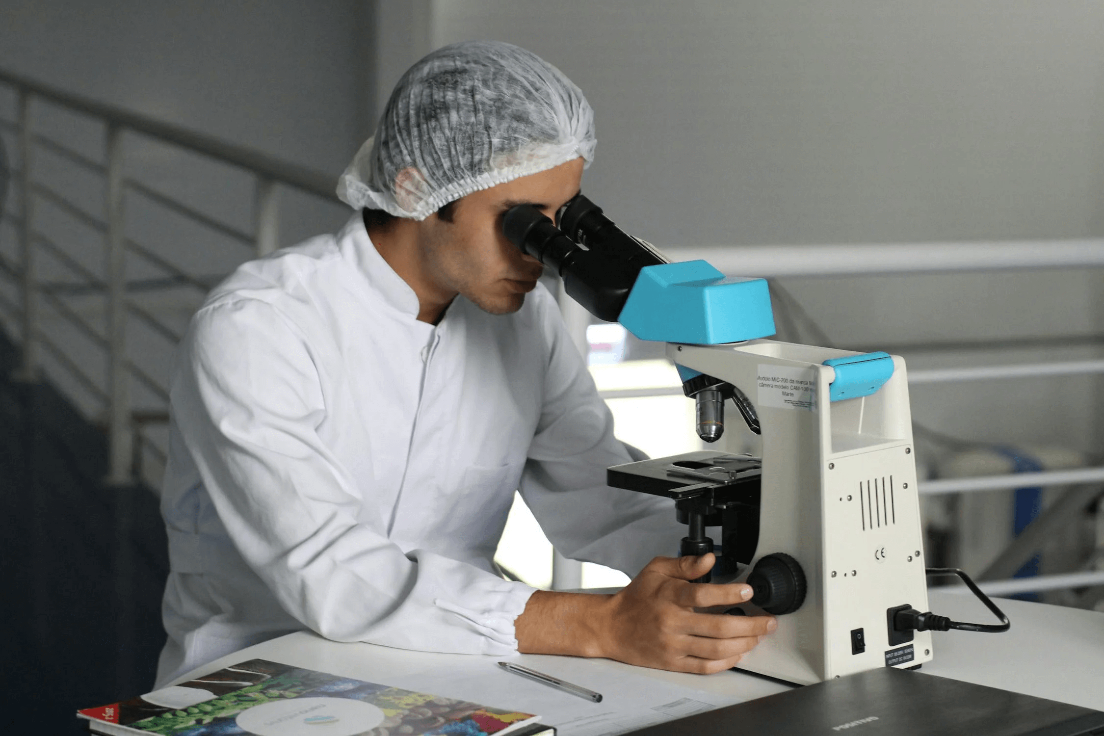 Scientist in a laboratory looking into a microscope