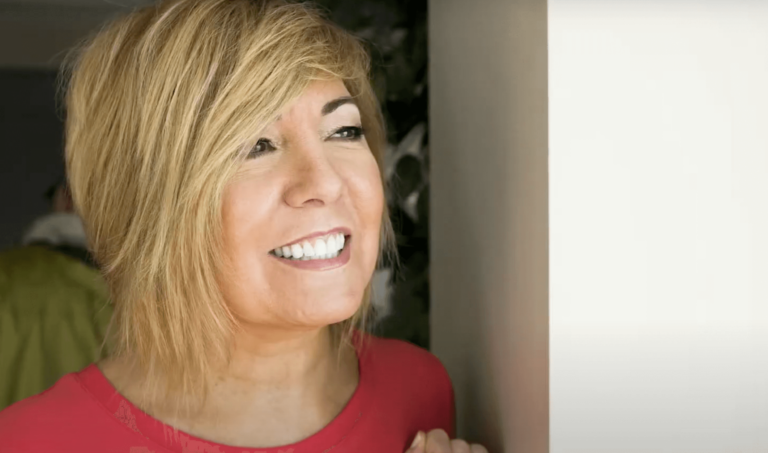 Kim Adamle, wife of former NFL player and sportscaster Mike Adamle, smiling and staring outside