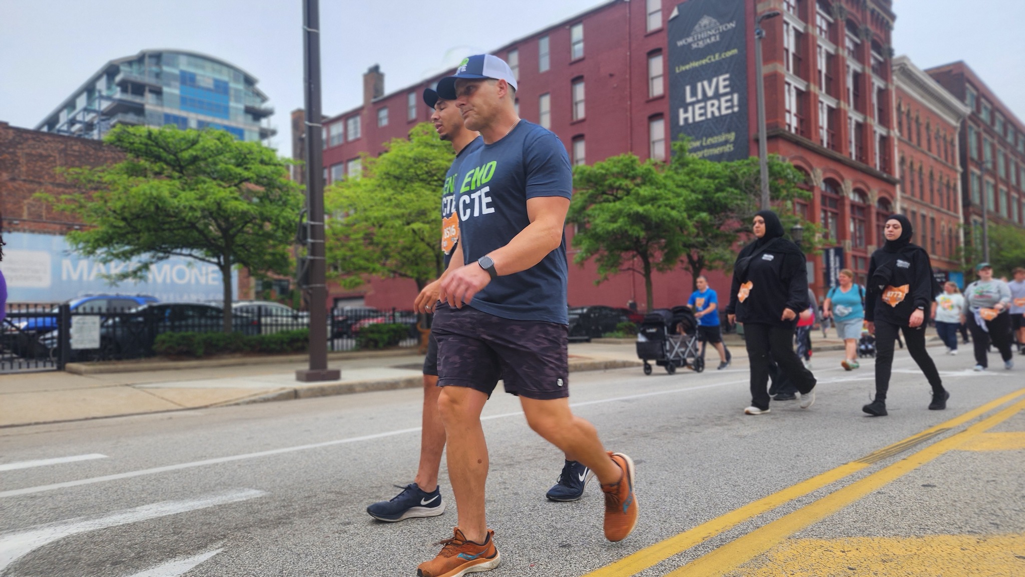 Two men in End CTE shirts walking in the street as part of the Concussion Legacy Foundation’s 2024 Race to End CTE in Cleveland
