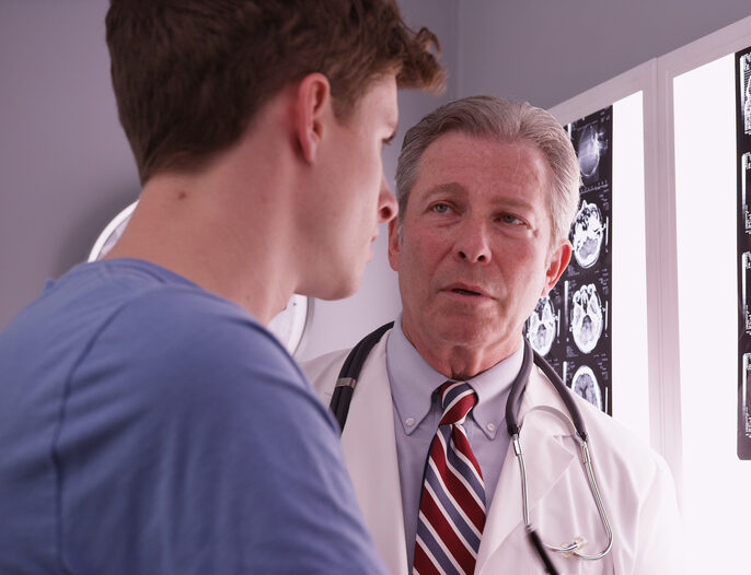 Physician and patient examine the results of a brain scan