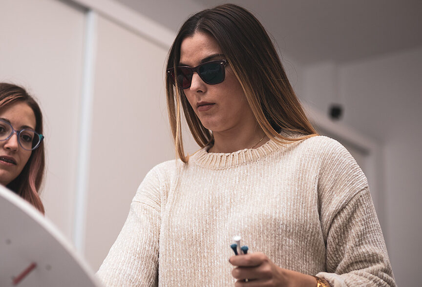 Patient in sunglasses undergoing oculomotor training at the doctor’s office