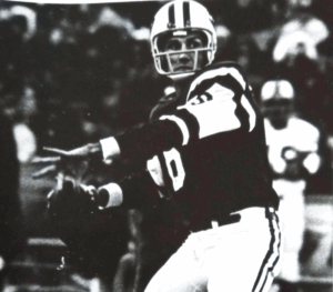 Former NFL quarterback and Legacy Bill Demory prepares to throw a football