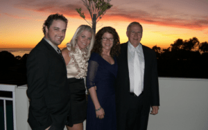 Legacy Donor and former college football player Jim Huge in a suit with his family