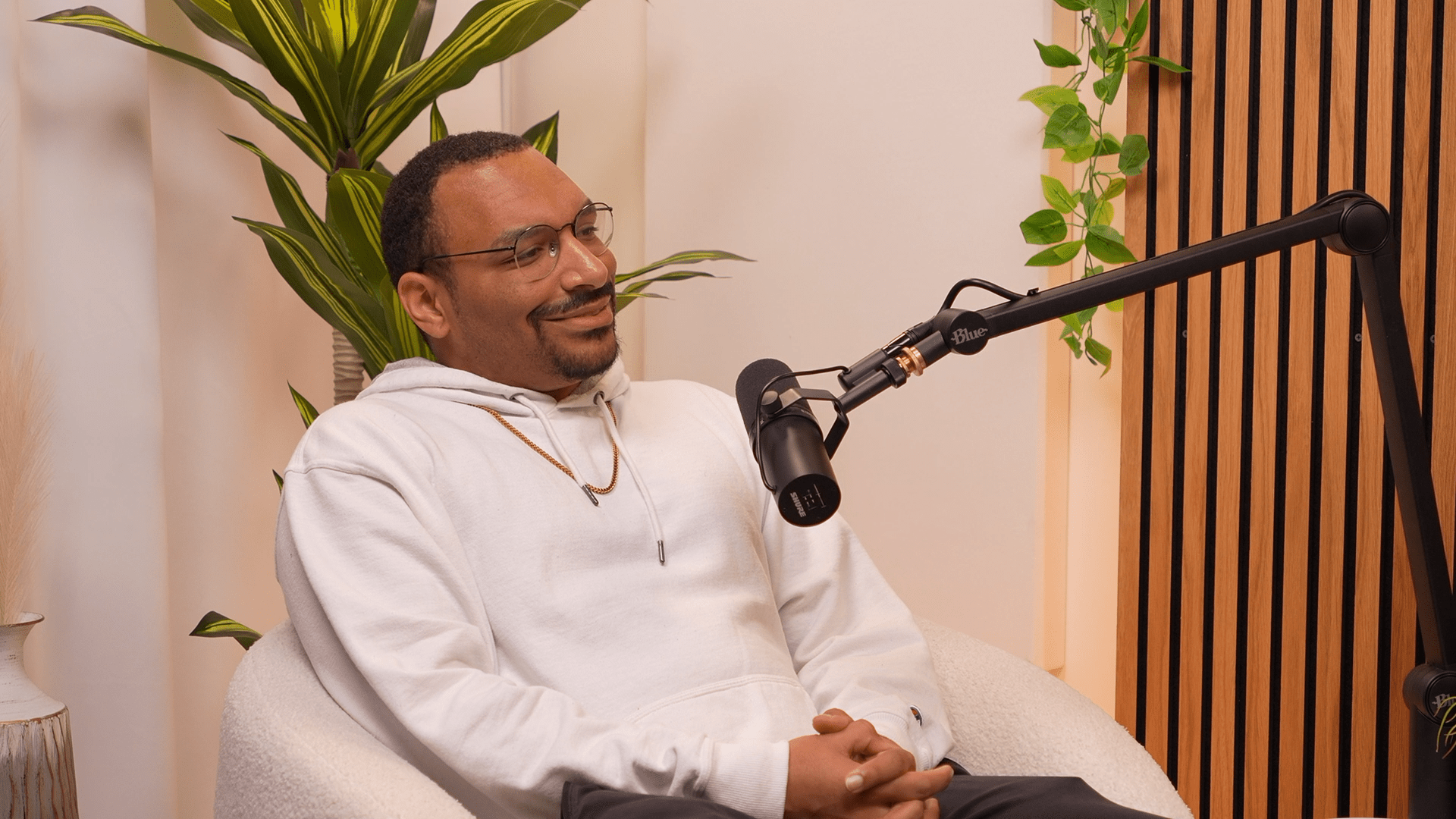 Chicago-based visual artist Anthony Bartley speaks into a microphone for Invisible Impact podcast