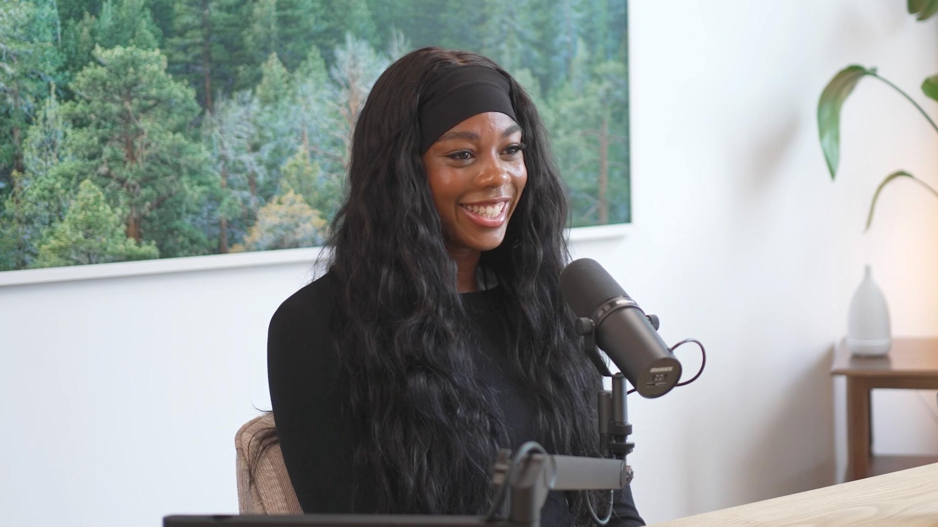 Professional soccer player Kennedy Faulknor speaks into a microphone for Invisible Impact podcast