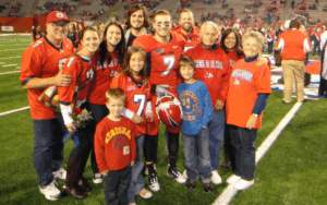 Former NFL player and Legacy Donor Devon Wylie with his family on the field at Fresno State