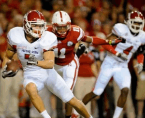 Former NFL player and Legacy Donor Devon Wylie jukes a defender on the field