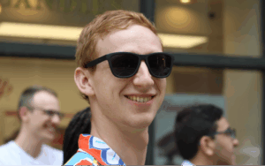 Legacy Donor Liam Roeth smiles in sunglasses
