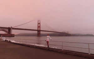 Former soccer player Caroline Souza standing in front of the Golden Gate Bridge