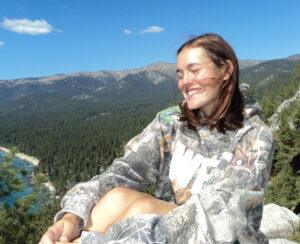 Former soccer player Caroline Souza smiles while on a hike