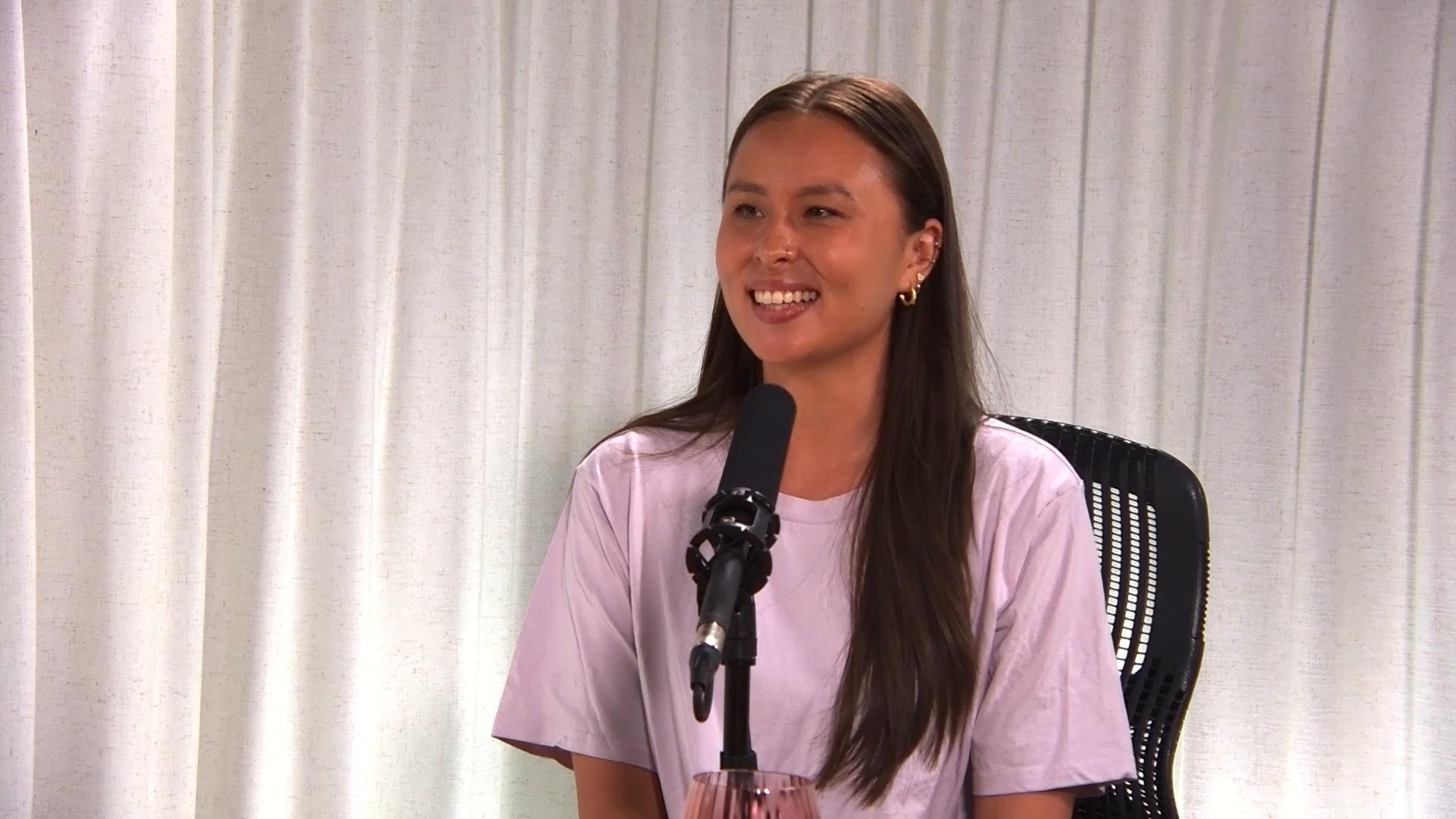 Professional soccer player Kennedy Faulknor speaks into a microphone for Invisible Impact podcast