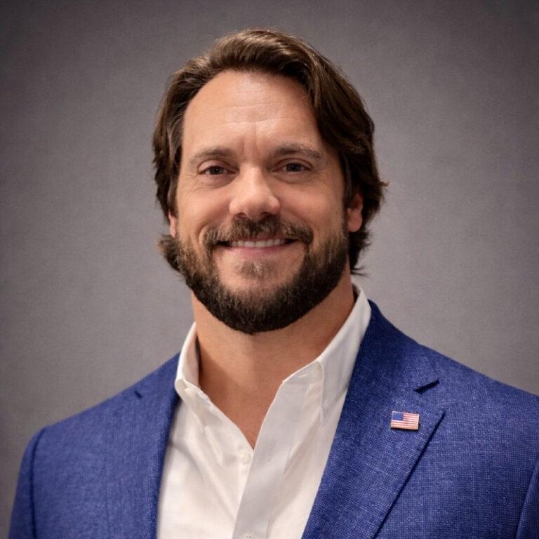 Concussion & CTE Foundation Veteran Advisory Board member Richard Junot Jr. in a suit