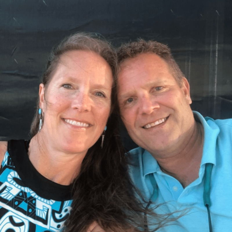 Jim and Caroline Yost smile on the beach