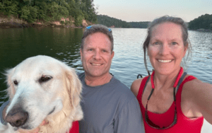 Jim and Caroline Yost on a boat with their dog