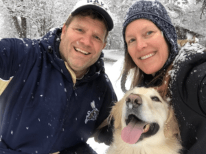 Jim and Caroline Yost with their dog in the snow