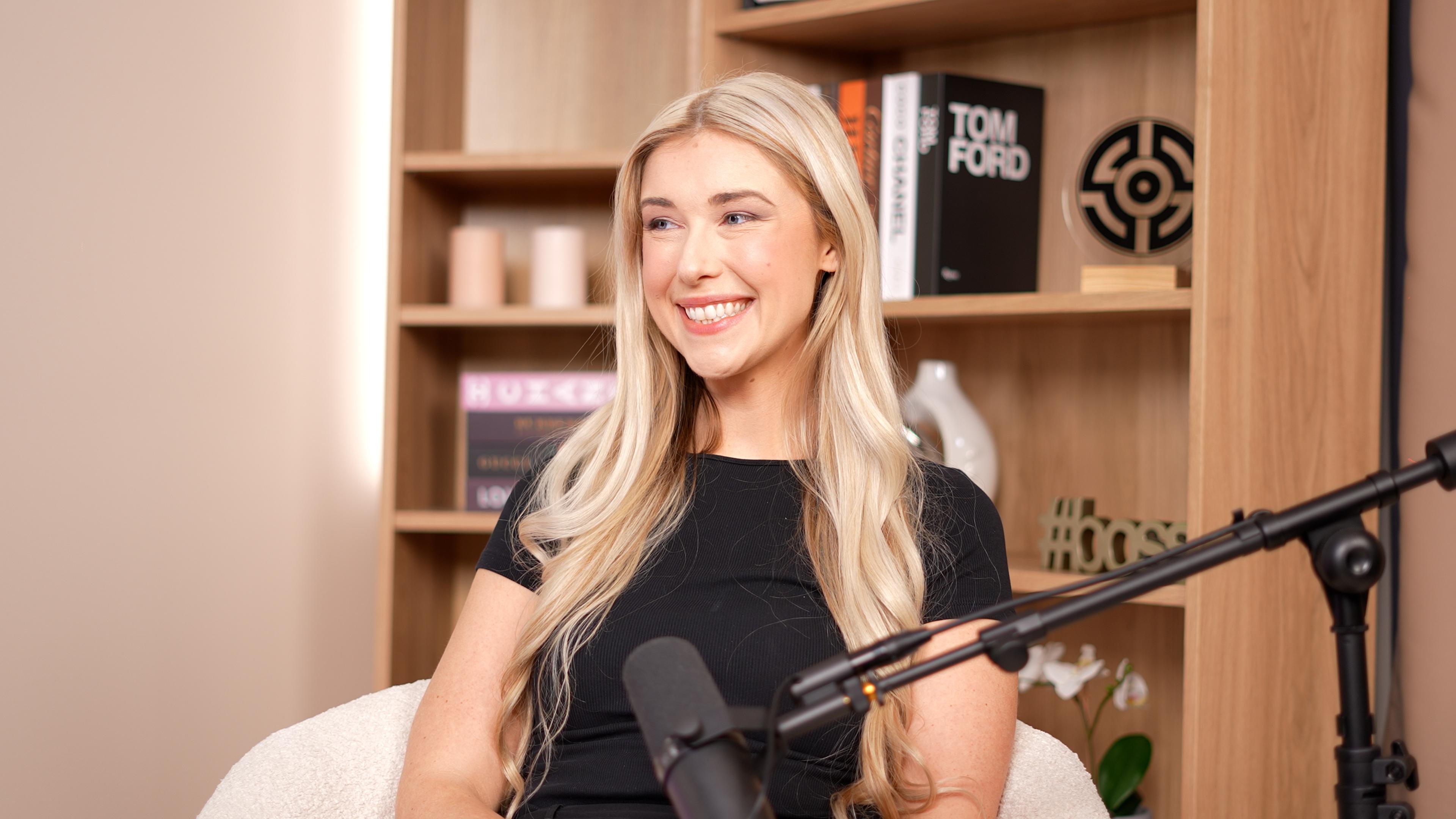 Kyla Jamieson speaks in front of a microphone for the Invisible Impact podcast