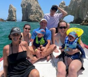 Legacy Donor and former hockey player Cam Brown with family on a boat in the ocean